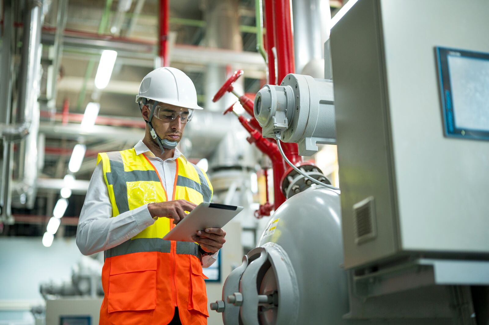 Auditor Using Touch Pad to Assess Equipment in Boiler Room